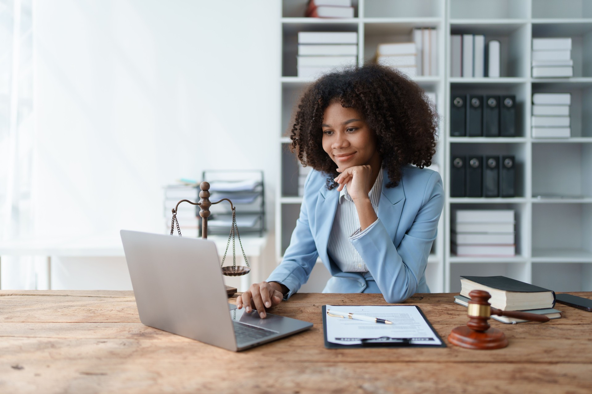A young women African American lawyer lawsuit studying cases for clients in a law firm to fight against their parties in the courts. law and attorney concepts.